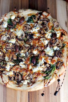 a pizza sitting on top of a wooden cutting board