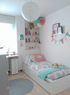 a child's bedroom with a bed, desk and shelves