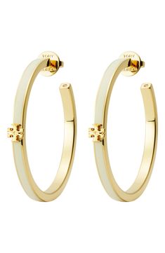 A signature double-T ornament charms the curves of these enamel-trimmed hoops that add a subtle splash of elegance to your lobes. Post back 1 5/8" hoop diameter 18k-gold plate/enamel/crystal Imported Luxury White Enamel Earrings, Gold Enamel Hoop Jewelry, Elegant Enamel Hoop Jewelry, Small Elegant Enamel Hoop Earrings, White Enamel Small Hoop Earrings, Classic White Hoop Earrings With Polished Finish, White Hoop Jewelry With Polished Finish, White Polished Hoop Jewelry, Elegant Enamel Hoop Earrings