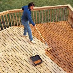 a man with a mop is cleaning the deck