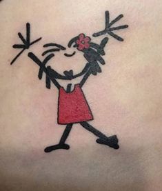 a woman's back with a cartoon character tattoo on her left side ribcage