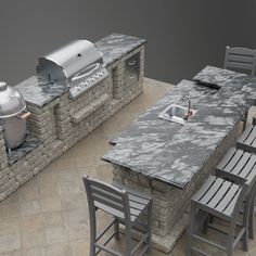 an outdoor kitchen with grill, table and chairs next to brick wall that looks like it has been built into the ground