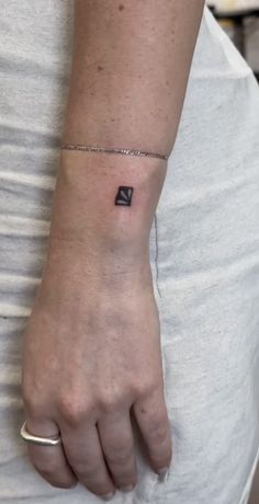 a person with a small tattoo on their wrist