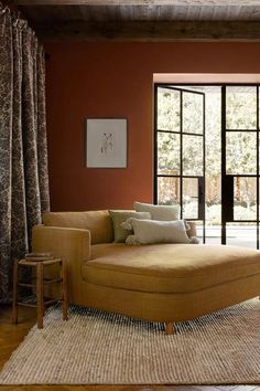 a living room filled with furniture and lots of window sill space next to a door