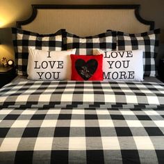 a black and white checkered bedspread with two pillows that say i love you more