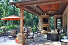 a covered patio with furniture and an umbrella