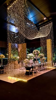 an indoor wedding setup with white flowers and chandeliers