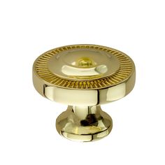 an antique brass cabinet knob on a white background