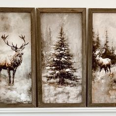 three framed paintings of deer and pine trees in the snow, one with antlers on it