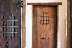 two wooden doors with iron bars on them