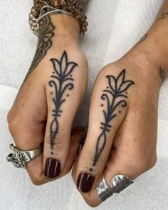 two hands with tattoos on them and one has a flower tattoo on the other hand