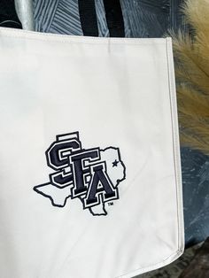 Show off your SFA pride with our SFA TX Logo Tote Bag. Perfect for everyday wear, this tote is a must-have for any SFA fan. Swing it over your shoulder and strut your team spirit in style! Logo Tote Bag, Stylish Shirts, Team Spirit, Suits You, Fashion Games, The Struts, In Style, Casual Looks, Unique Style