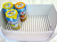 four jars of condiments sitting on top of an ice cream maker's tray