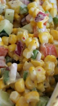 a bowl filled with corn and vegetables on top of a table