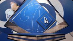 the los angeles dodgers baseball team logo is seen in front of an image of a man's face