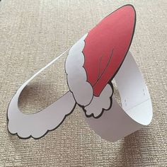 a red and white paper hat on top of a table