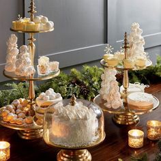 three tiered trays filled with cakes and cupcakes on top of a table