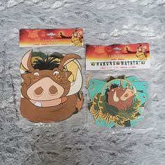 the lion and the mouse stickers are in plastic bags on a gray surface with other items