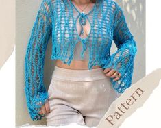 a woman wearing a blue crochet sweater and shorts with her hands on her hips