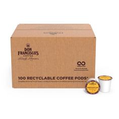 two coffee pods in front of a cardboard box