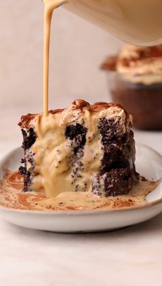 someone is pouring caramel sauce on a piece of chocolate cake with oreo crust