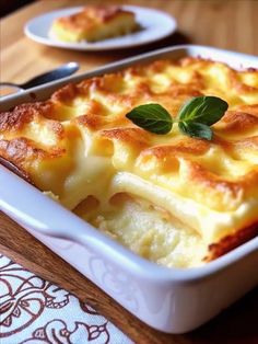 a casserole dish with cheese and basil on top