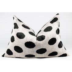 a black and white pillow with polka dots on it