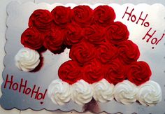 a red and white cake with frosting on it's face that says ho ho ho