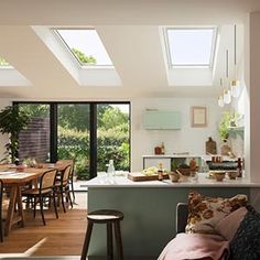 an open kitchen and dining room with skylights