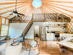 the inside of a home with wood floors and vaulted ceiling