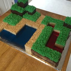 a cake made to look like a house with grass on the outside and water in the middle