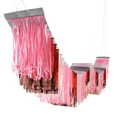 a group of pink lights hanging from strings