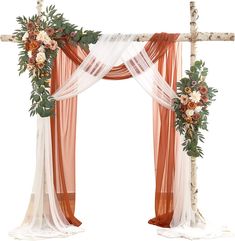 an orange and white wedding arch decorated with flowers, greenery and sheer drapes