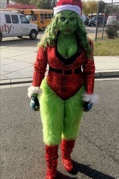 a woman dressed up as the grinch