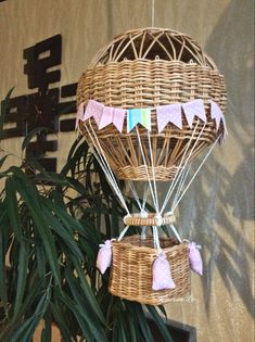 a hot air balloon hanging from the ceiling next to a potted plant