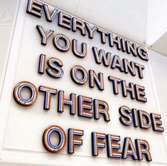 a sign that says everything you want is on the other side of fear