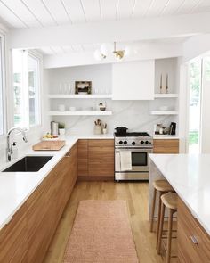 the kitchen is clean and ready for us to use it's counters are white with wood trim