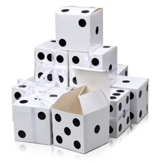 several white boxes with black polka dots are stacked on top of each other and one is open