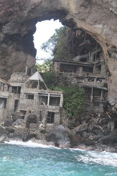 an old house built into the side of a cliff