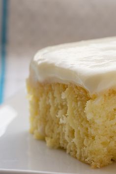 a close up of a piece of cake on a plate with white frosting and icing