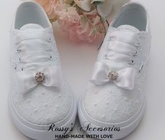 "Beautiful and cute Custom All White Low-top canvas Authentic Vans Sneakers for baby toddlers are embellished with white lace fabric and a White Satin Ribbon shoe lace for tying, Small White Bow and Rhinestone, with small White pearls around de shoes Handmade to order, so please allow me enough time before your wedding date. Orders are processed and shipped within 4-5 WEEKS of payment., large orders may take longer ..Please allow an additional 2-5 days. Domestic Shipping will take 2-5 Business d Lace Converse, Ribbon Shoe Laces, Lace Toms, Communion Shoes, First Communion Shoes, Bridal Converse, Bridal Flip Flops, Ribbon Shoes