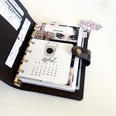 an open planner book sitting on top of a table