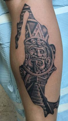 a tattoo on the leg of a person wearing a mask and holding a knife in his hand