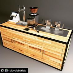 a wooden counter topped with lots of different types of coffee machines on top of it