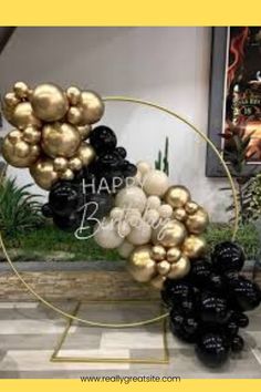 black and gold balloons are arranged in a circle