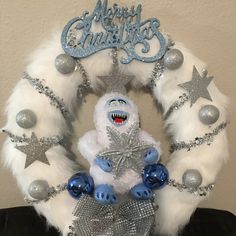 a christmas wreath with silver and blue decorations