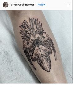 a black and white tattoo on the leg of a person with an eagle head design