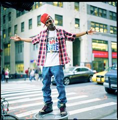 a man standing on top of a skateboard in the middle of a city street