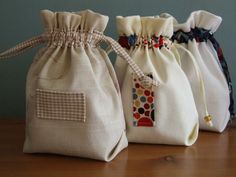 three bags with ties on them sitting on a table