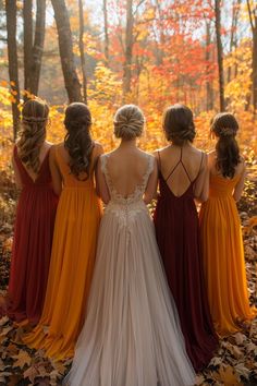 four bridesmaids standing in the woods with their backs to the camera